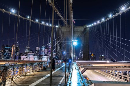 Photo for Brooklyn bridge pedestrian walkway at night in New York City, NY, USA - Royalty Free Image