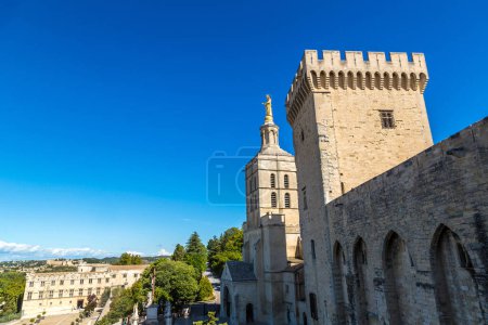 Photo for Christian cross in front of Cathedral and Papal palace in Avignon in a beautiful summer day, France - Royalty Free Image