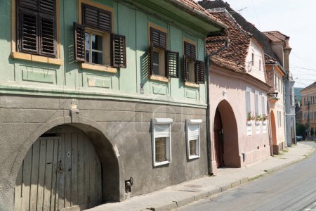 Photo for Old  medieval houses in  Sighisoara, Romania,  in well-preserved old town, listed by UNESCO as a World Heritage Site - Royalty Free Image