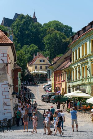 Photo for SIGHISOARA, ROMANIA - august 8, 2019:  People walking old  medieval streets in  Sighisoara, Romania,  in well-preserved old town, listed by UNESCO as a World Heritage Site - Royalty Free Image