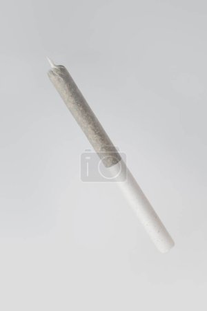 rolled joint of medical cannabis on a gray background