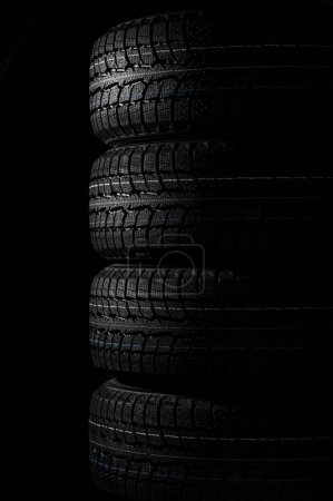 Photo for A set of winter tires four wheels on black - Royalty Free Image
