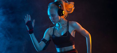 Photo for Strong athletic fit woman on black background wearing in the sportswear. Fitness and sport motivation. Download vertical banner for sports website or mobile application. - Royalty Free Image