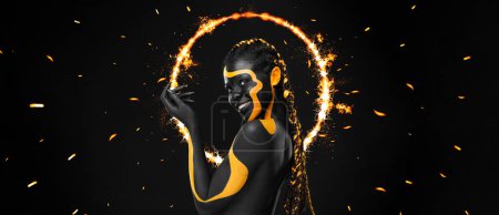 Photo for Yellow and black body paint. Woman with face art. Young girl with bodypaint. An amazing model with makeup. - Royalty Free Image