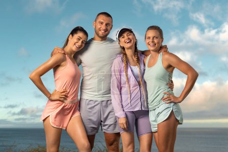 Photo for Certified instructor and his team of trainees. Download high resolution photo smiling women and man fitness team. A happy group of runners rest after running - Royalty Free Image