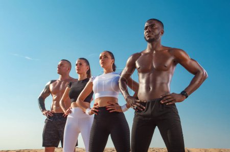Foto de A team of athletes with athletic body in the summer outdoors go in for sports, jogging and running. Download a photo to advertise on social networks, sports running magazines and fitness websites - Imagen libre de derechos