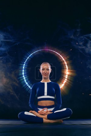 Foto de Download photo for yoga classes ads. Yoga asana Indoor. Sports recreation. Beautiful young woman in yoga pose. Individual sports. - Imagen libre de derechos