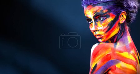 Photo for A girl in a glowing neon circle. Woman in color body painting on her face. Cover art for your mixtape, video, song or podcast. Design for book cover - Royalty Free Image