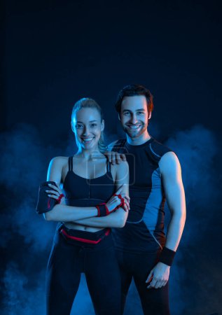 Photo for Download photo for advertising a fitness club in social networks. Fitness Influencers. Fitness couple at home. Cover for sport motivation music. Fit man and woman at the gym on black background. - Royalty Free Image