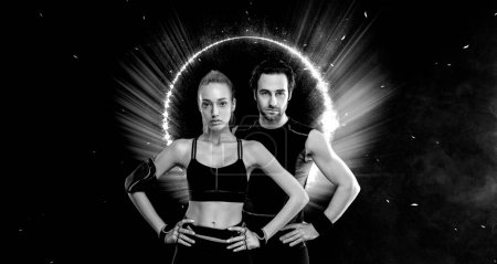 Photo for Download photo for advertising a fitness club in social networks. Fitness Influencers. Fitness couple at home. Cover for sport motivation music. Fit man and woman at the gym on black background - Royalty Free Image