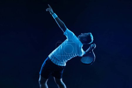 Photo for Padel tennis player with racket. Man athlete with racket on court with neon colors. Sport concept. Download a high quality photo for the design of a sports app or betting site - Royalty Free Image