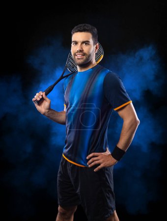 Photo for Squash player on a squash court with racket. Man athlete with racket on court with neon colors. Sport concept. Download a high quality photo for the design of a sports app or betting site - Royalty Free Image