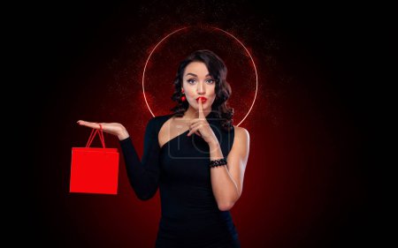 Photo for Beautiful young woman make shopping in black friday holiday. Girl with black bag on dark background. - Royalty Free Image