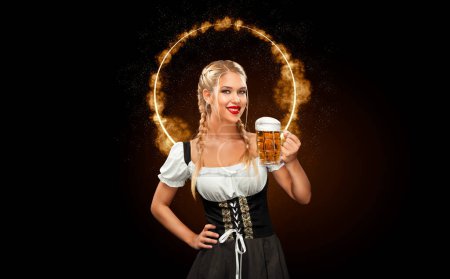 Photo for Half-length portrait of young sexy blonde with big breast wearing black dirndl with white blouse holding the beer mug Isolated on dark background - Royalty Free Image