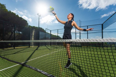 Photo for Padel tennis player with racket. Girl athlete with paddle racket on court outdoors. Sport concept. Download a high quality photo for the design of a sports app or web site - Royalty Free Image