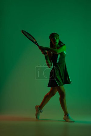 Photo for Tennis player with racket in white costume. Woman athlete playing isolated on black background - Royalty Free Image