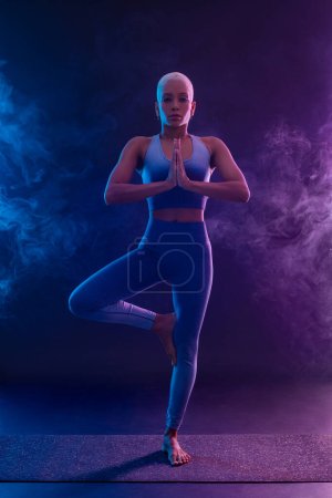 Photo for Download photo for yoga classes ads. Yoga asana Indoor. Sports recreation. Beautiful young woman in yoga pose. Individual sports. - Royalty Free Image