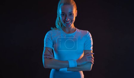 Photo for Strong athletic fit woman on black background wearing in the sportswear. Fitness and sport motivation - Royalty Free Image