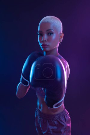 Photo for The Boxing. Brazilian woman boxer. Sportsman muay thai boxer fighting in gloves. Isolated on black background. Copy Space - Royalty Free Image