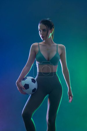 Foto de Soccer player. Athlete in football sportswear on game with ball. Sport concept - Imagen libre de derechos
