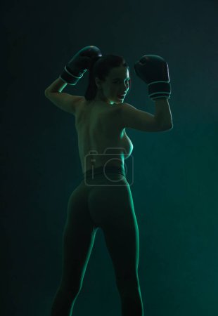 Photo for The Boxing. Brazilian woman boxer. Sportsman muay thai boxer fighting in gloves. Isolated on black background. Copy Space - Royalty Free Image
