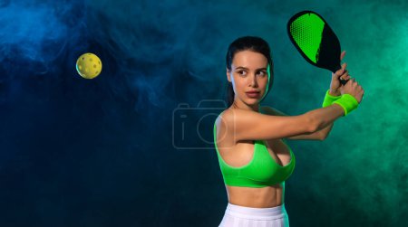 Photo for Pickleball tennis player with racket on the court. Sport court and balls. Download a high quality photo with paddle for the design of a sports app or social media advertisement - Royalty Free Image