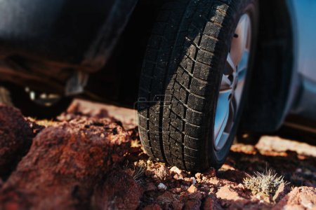 Photo for Car wheel standing on stones close-up view - Royalty Free Image