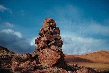 Photo for Hand-made stone tower in mountains on sky background - Royalty Free Image