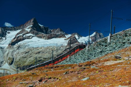 Photo for Red train in high Alps mountains - Royalty Free Image