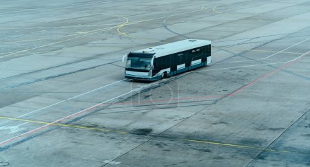 Photo for Airport shuttle bus on an airfield, airport travel scene - Royalty Free Image