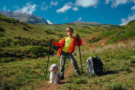 Photo for Boy hiker with shih-tzu dog in the mountains - Royalty Free Image