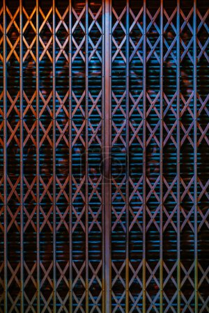 Photo for Metallic gate with geometric pattern at night - Royalty Free Image