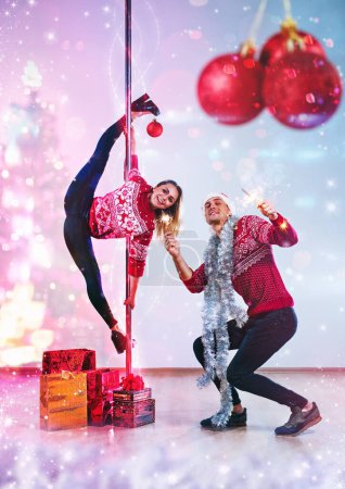 Photo for Young man and woman pole dancers celebrating new year concept - Royalty Free Image