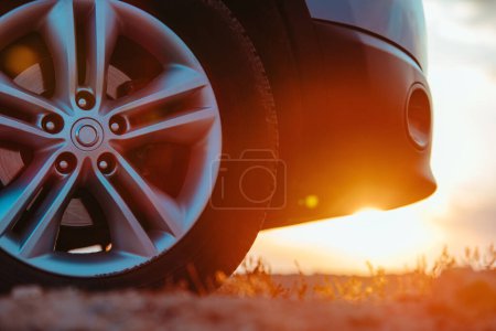Photo for Car wheel close-up view in desert area at sunset - Royalty Free Image