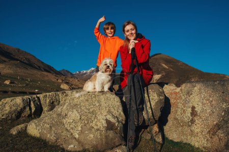 Photo for Happy mother and son with shih tzu dog portrait in the mountains - Royalty Free Image