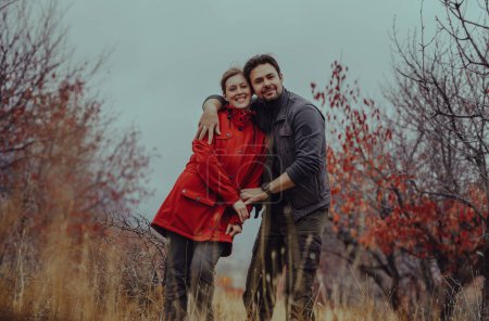 Photo for Happy young couple of tourists in the mountains in autumn - Royalty Free Image