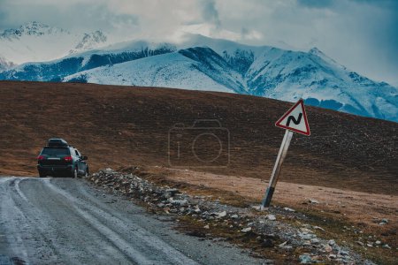 Photo for Travel car and dangerous turn sign on mountain road - Royalty Free Image