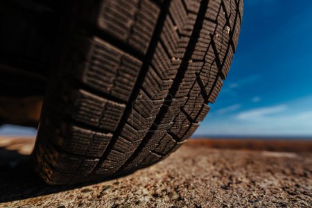 Photo for Car tire on stone close-up wide angle view - Royalty Free Image