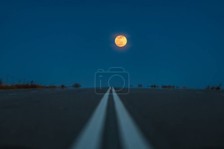 Photo for Road perspective at dusk with big moon - Royalty Free Image
