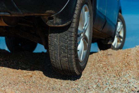 Photo for Car rear wheel no contact with ground on sand hill offroad drive - Royalty Free Image