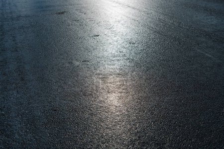 Photo for Wet asphalt after rain on a bright sunny day - Royalty Free Image