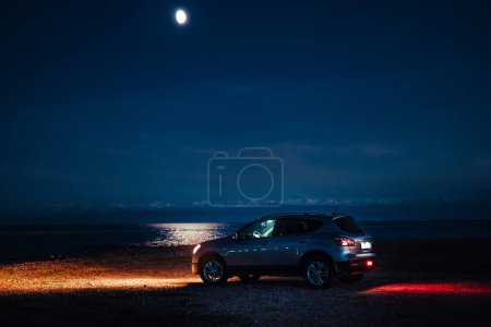 Photo for Nissan Qashqai car on the lake shore at night time - Royalty Free Image