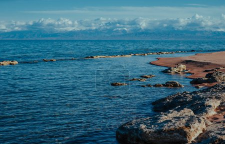 Photo for Rocky lake shore of Issyk-kul lake in Kyrgyzstan in spring - Royalty Free Image