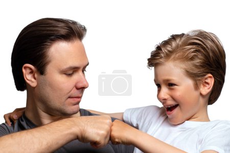Foto de Happy father and son giving a fist bump isolated on white background - Imagen libre de derechos