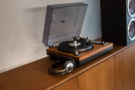 Photo for Home Stereo Turntable System Placed on Retro Self with Space for Text. Includes Vintage Vinyl Record Player, Headphones and Speakers. - Royalty Free Image
