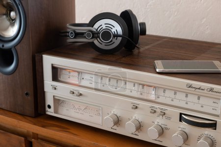 Photo for Home Stereo Receiver with Speakers and Headphones Placed on Wooden Retro Shelf. Includes Phone as a Source, New and Old Technology Working Together. - Royalty Free Image