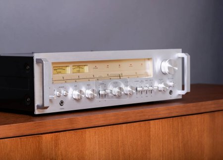 Photo for Professional Audio Stereo Receiver with Handles and VU meters. Audio Gear Component with Highlighted Meters and Silver Front Plate Angled view - Royalty Free Image