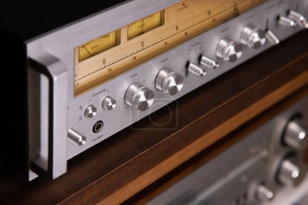 Photo for Professional Audio Stereo Receiver with Handles and VU meters. Audio Gear Component with Highlighted Meters and Silver Front Plate Closeup Angled view - Royalty Free Image