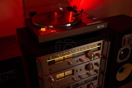 Photo for Ontario Canada - MAY 11, 2023: AKAI Vintage Stereo Audio Components Sound System Rack Tower with Turntable and Tuner with glowing light - Royalty Free Image