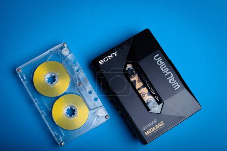 Photo for Ontario Canada - NOVEMBER 20, 2017: Sony Walkman Personal Vintage Analog Stereo Compact Cassette Player with Metal Type Tape with Reels on Blue Background - Royalty Free Image